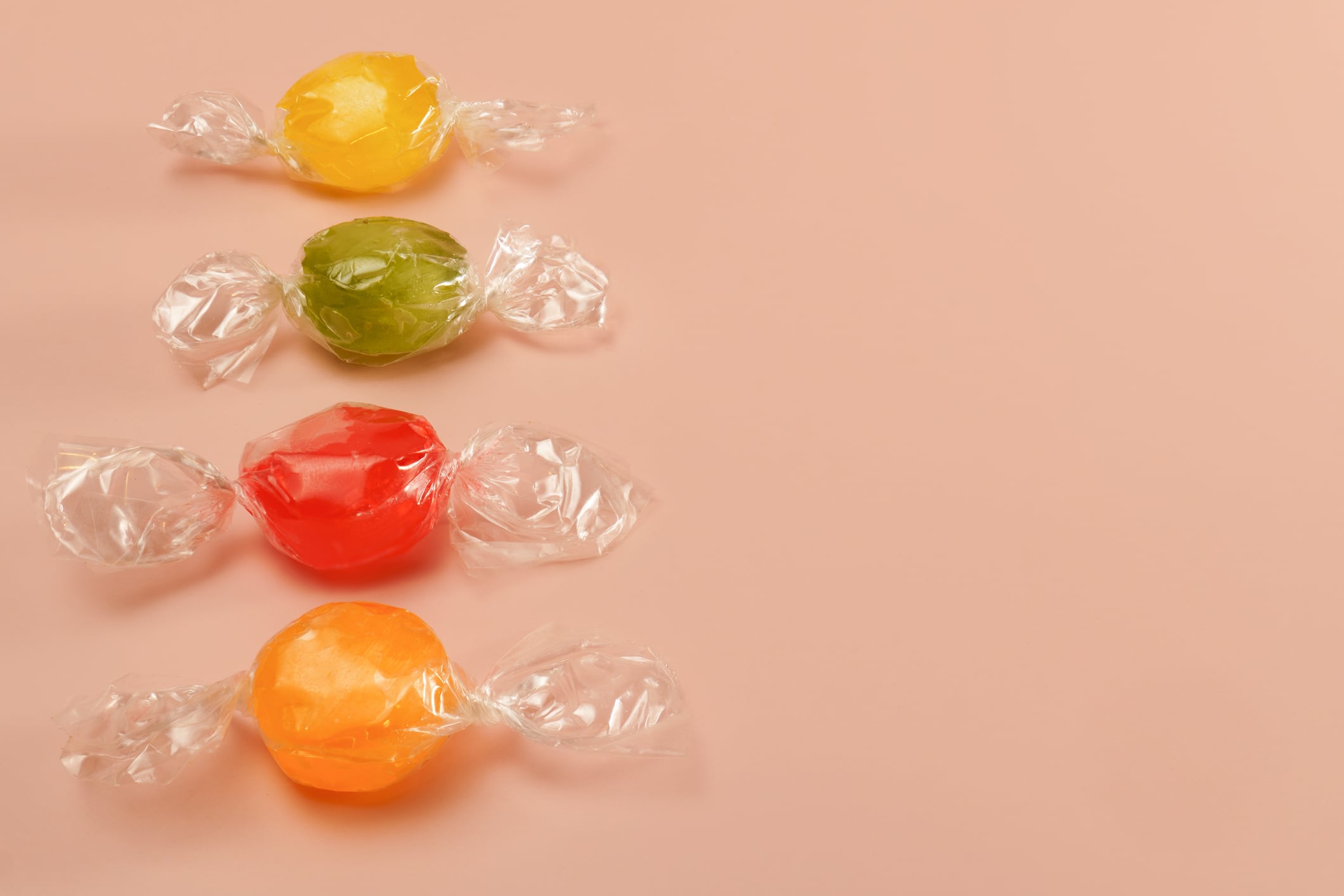 Coloured confectionery wrapped in plastic.