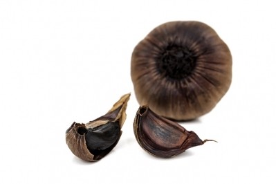 Aged black garlic extract can improve high blood pressure. Image Source: vovashevchuk/Getty Images