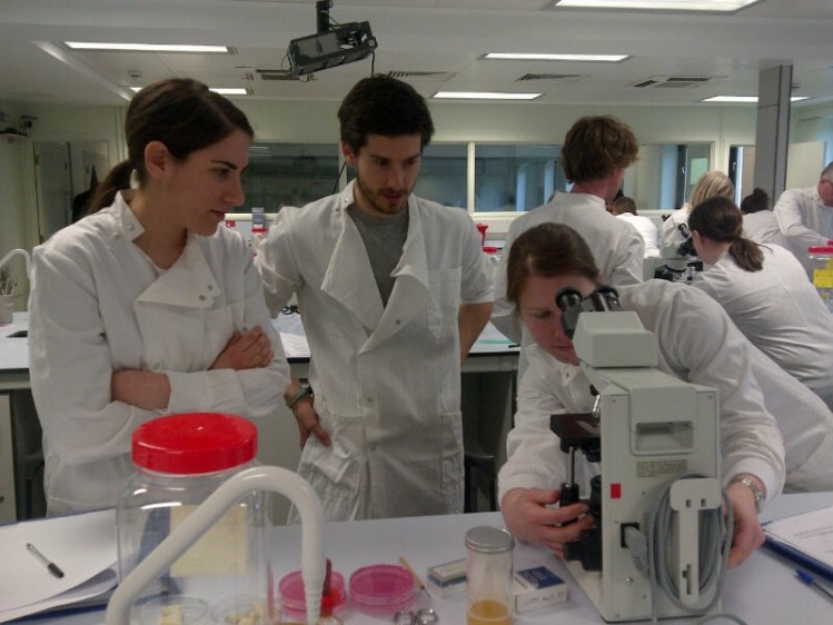 Picture: Government Chemist. Niki Georgousi, and Paul Evans watch Emma Downie setting up the microscope